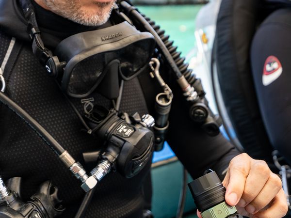 Diver on boat with underwater camera equipment